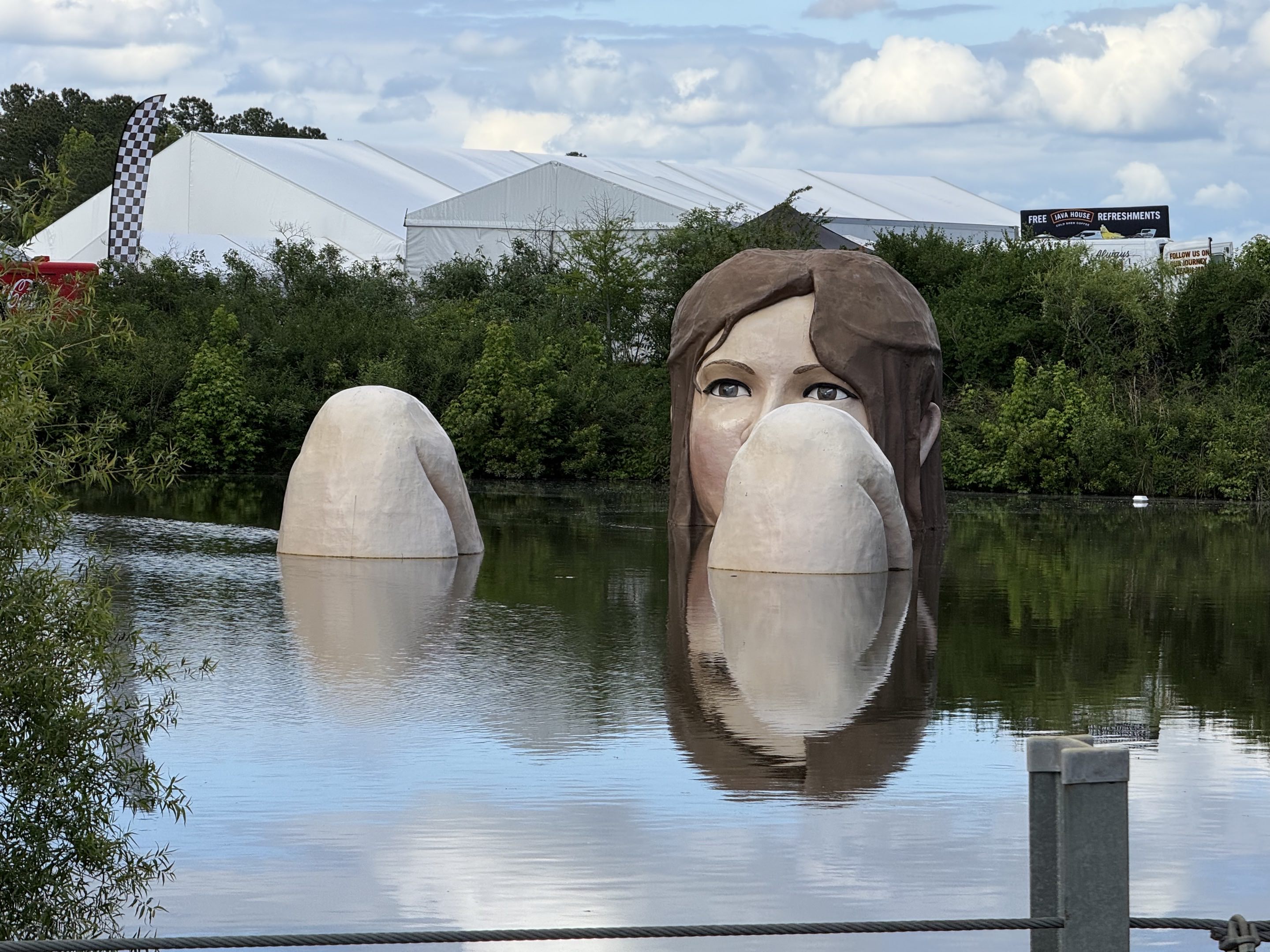 A statue of a giant lady bathing in the lake at Barber Motorsports Park